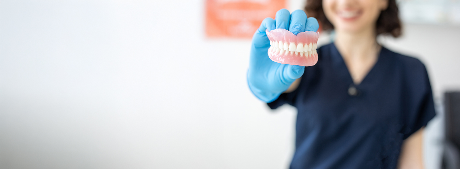 dentist holding dentures