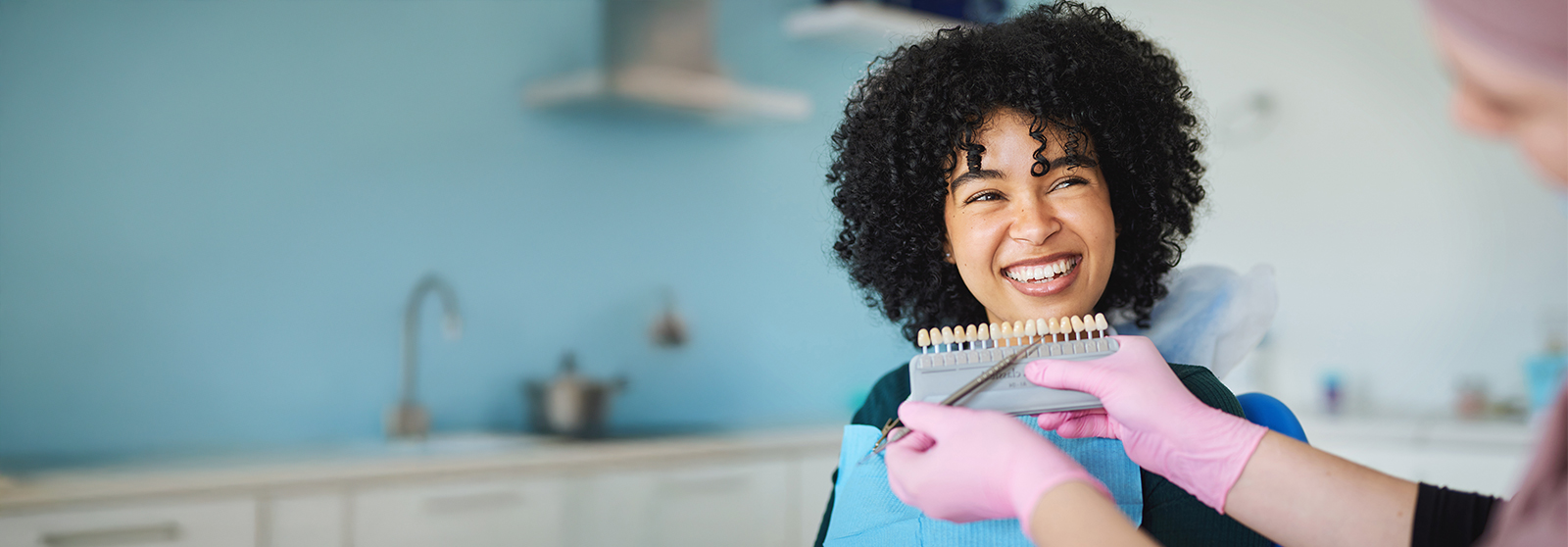 dentist matching crown to patient's tooth color