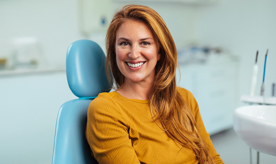 woman smiling wide during dentist visit